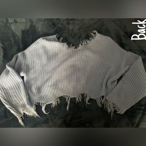 A cute, warm blue long sleeve top with some clouds.